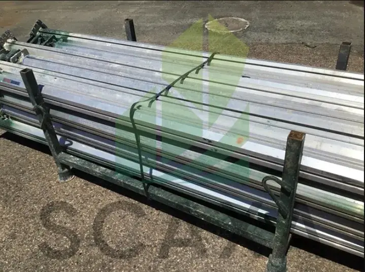 Aluminium props stacked securely on a rack, showcasing lightweight design and construction suitability for formwork support.