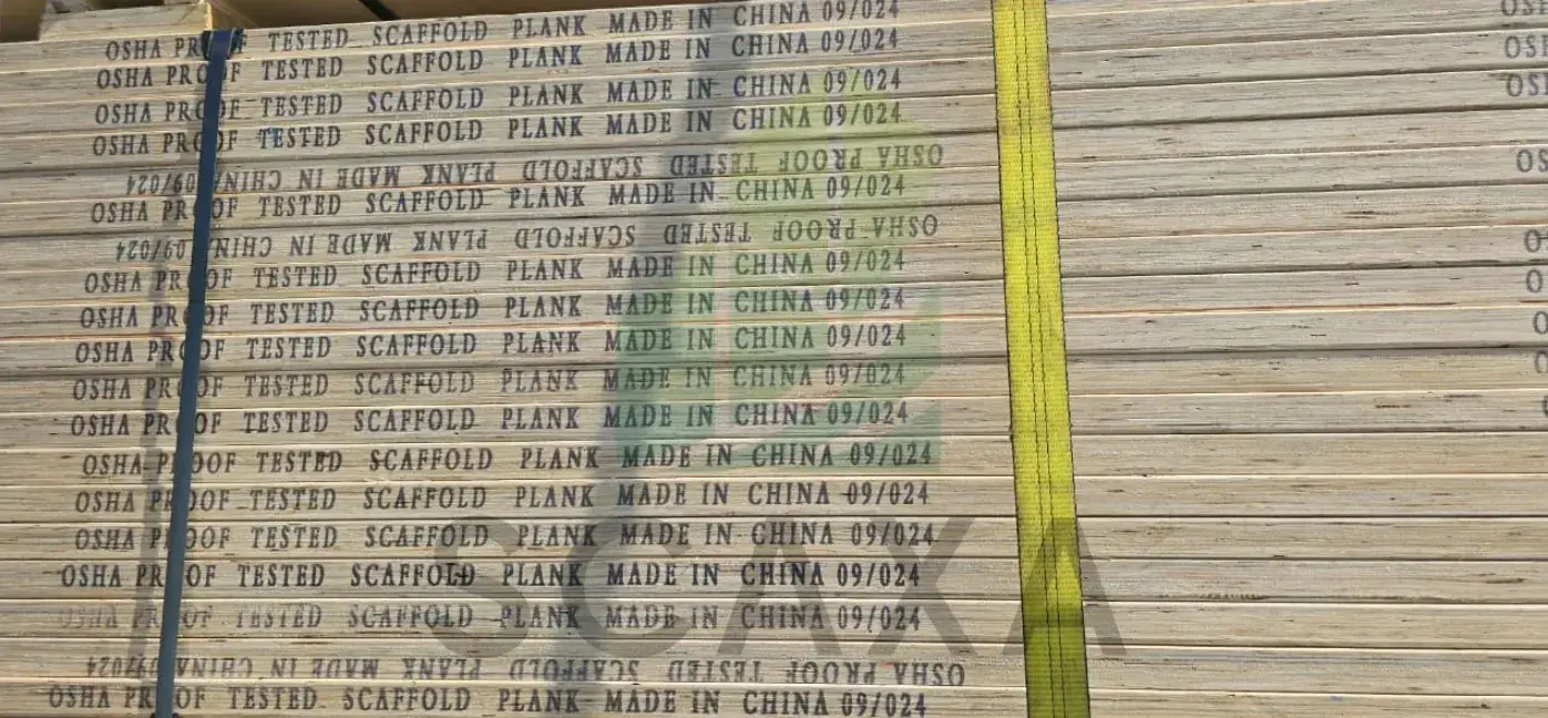 Wooden scaffold planks stacked, labeled "OSHA PRO TESTED," indicating safety compliance, with "MADE IN CHINA" and production dates visible.